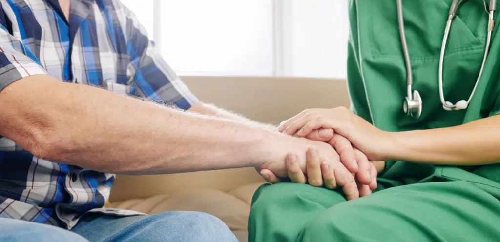 docotr holding hands with patient