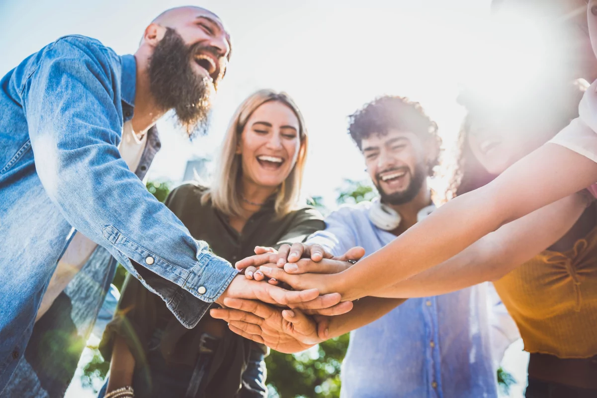 multiracial-happy-young-people-stacking-hands-on-t-2022-12-17-03-40-04-utc-1