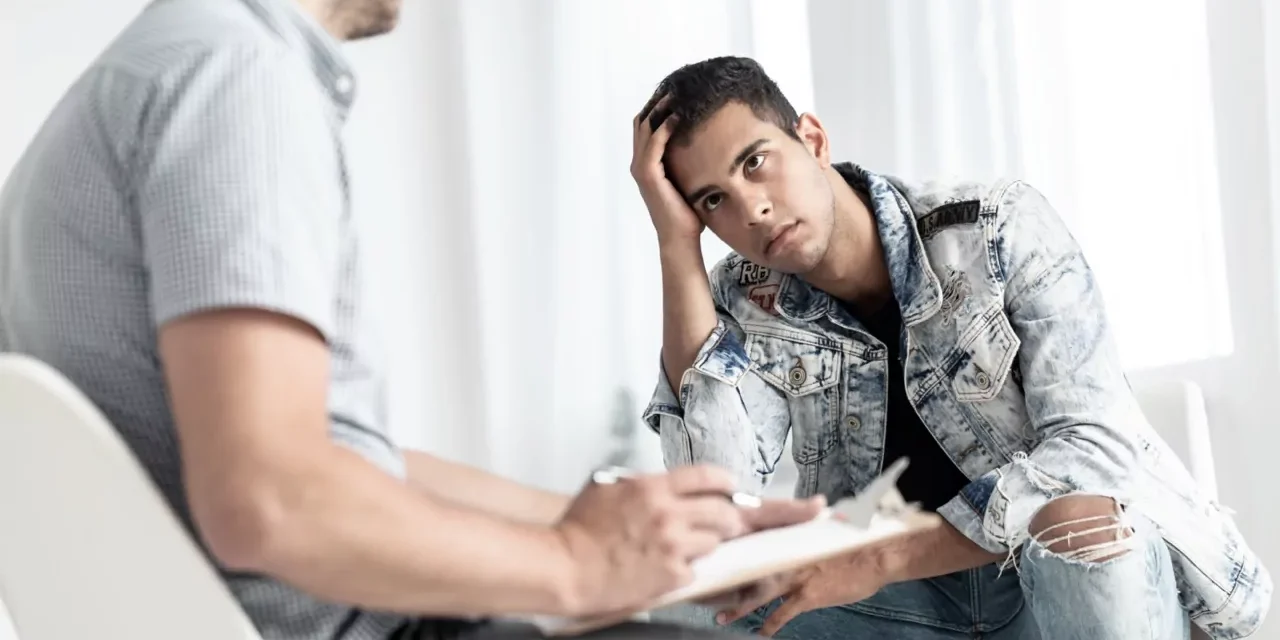 rebellious-spanish-man-listening-to-counselor-duri-2021-08-26-15-45-18-utc-Large