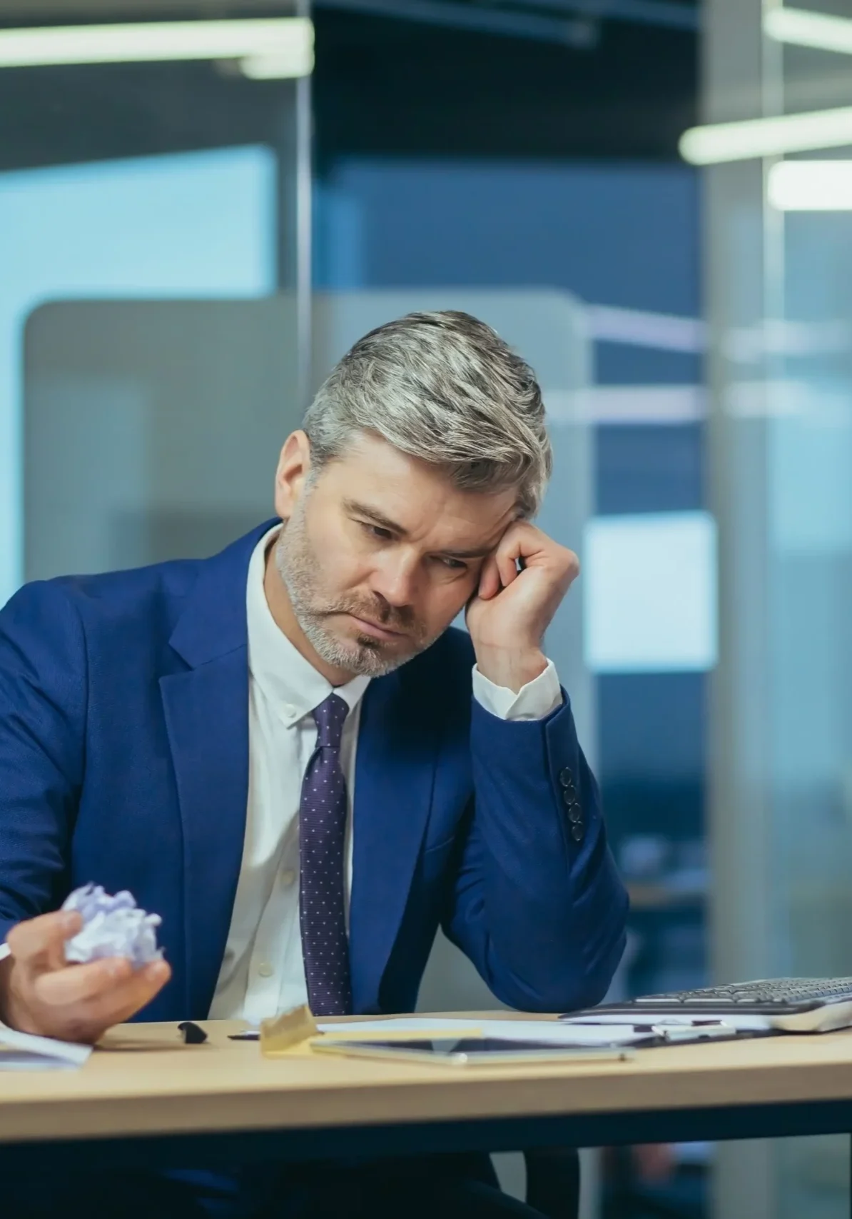 stressed-businessman-at-desk-scaled